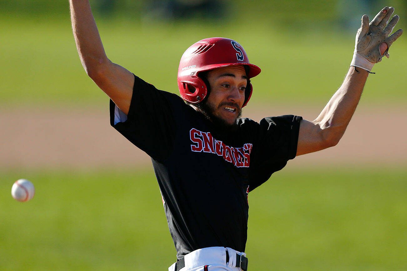 Snohomish captain Nickolas Sakamoto slides in safe at third before getting up and heading home on a throwing error during a matchup against Arlington on Friday, April 14, 2023, at Earl Torgeson Field in Snohomish, Washington. (Ryan Berry / The Herald)