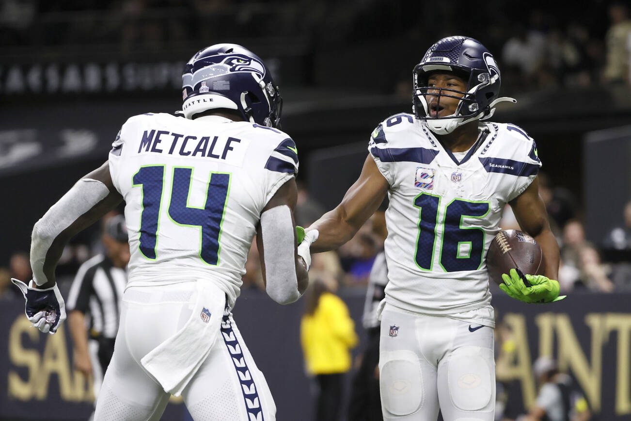 Seattle Seahawks wide receiver Tyler Lockett (16) celebrates his touchdown with wide receiver DK Metcalf during an NFL football game against the Seattle Seahawks in New Orleans, Sunday, Oct. 9, 2022. (AP Photo/Derick Hingle)