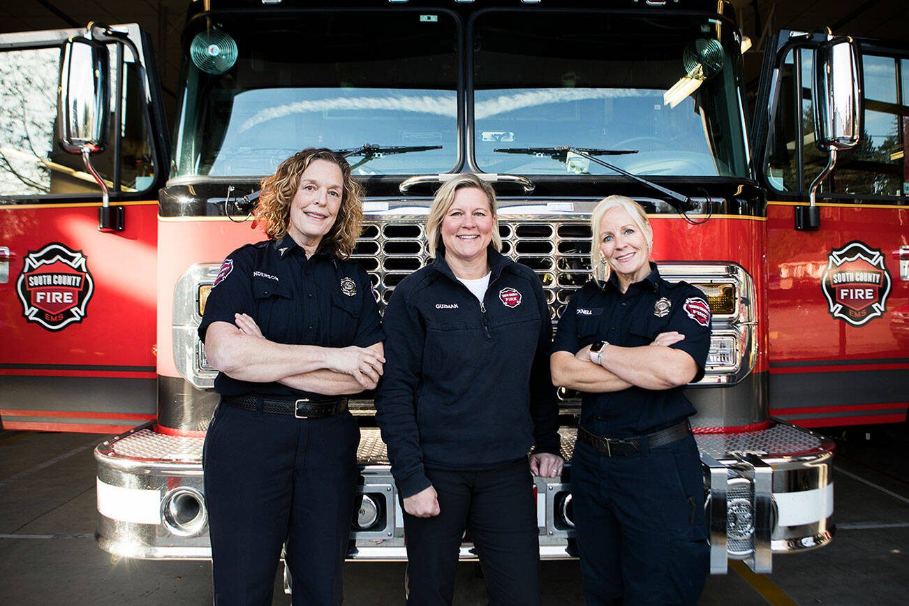 Shawneri Guzman, center, who was named Washington's Fire Educator of the Year and her team of Community Resource firefighter paramedics Janette Anderson, left, and Captain Nicole Picknell, right, at the Lynnwood Fire Station on Wednesday, Nov. 17, 2021 in Lynnwood, Wa. (Olivia Vanni / The Herald)