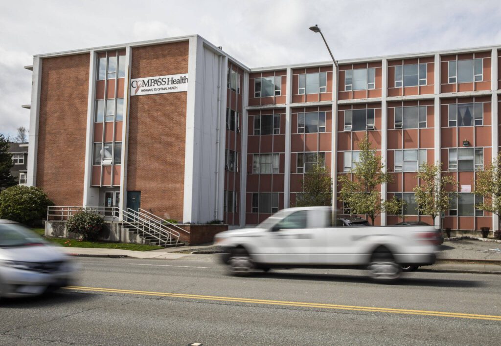 Traffic moves along Broadway in front of Compass Heath, one of the locations that would fall under the “no sit, no lie” ordinance extension on Tuesday, April 18, 2023 in Everett, Washington. (Olivia Vanni / The Herald)
