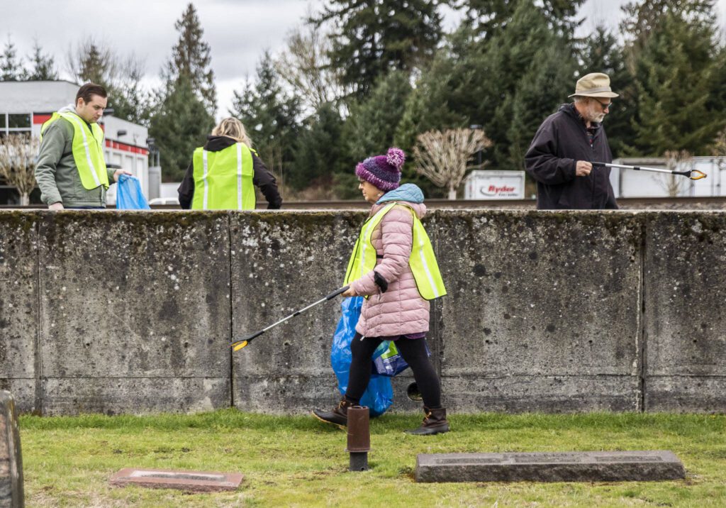Litter League volunteers walk along State Street and pick up trash on Tuesday, April 18, 2023, in Marysville, Washington. (Olivia Vanni / The Herald)
