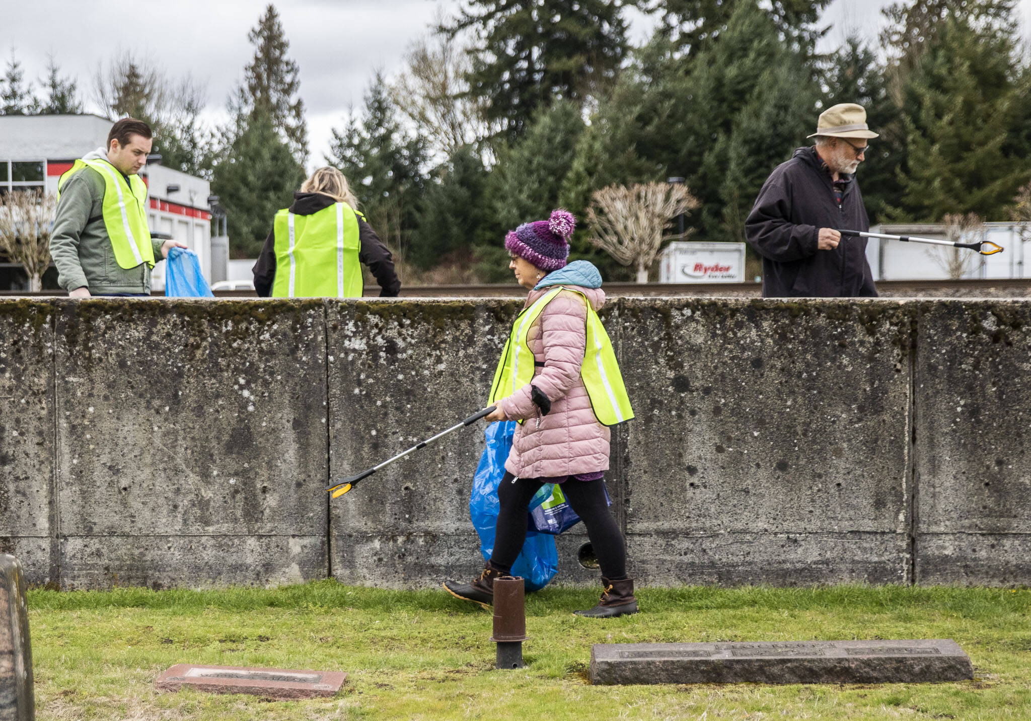Litter League volunteers walk along State Street and pick up trash on Tuesday, April 18, 2023, in Marysville, Washington. (Olivia Vanni / The Herald)
