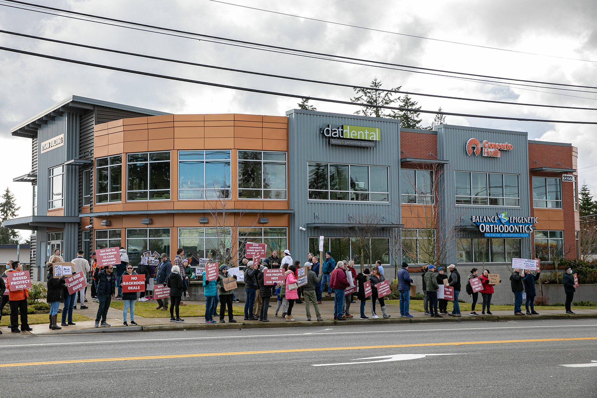 Locals from the group Safe Lynnwood gather in front of the Ryann Building on 196th Street SW to protest the opening of a methadone clinic in the building on Sunday, Jan. 22, 2023, in Lynnwood, Washington. (Ryan Berry / The Herald)