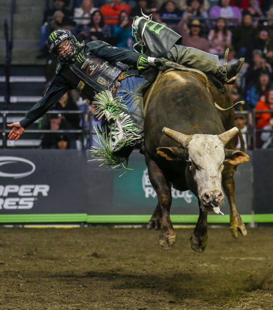 Boudreaux Campbell rides a bull during Unleash The Beast at Angel of the Winds Arena in Everett, Washington on Thursday, April 20, 2023. (Annie Barker / The Herald)
