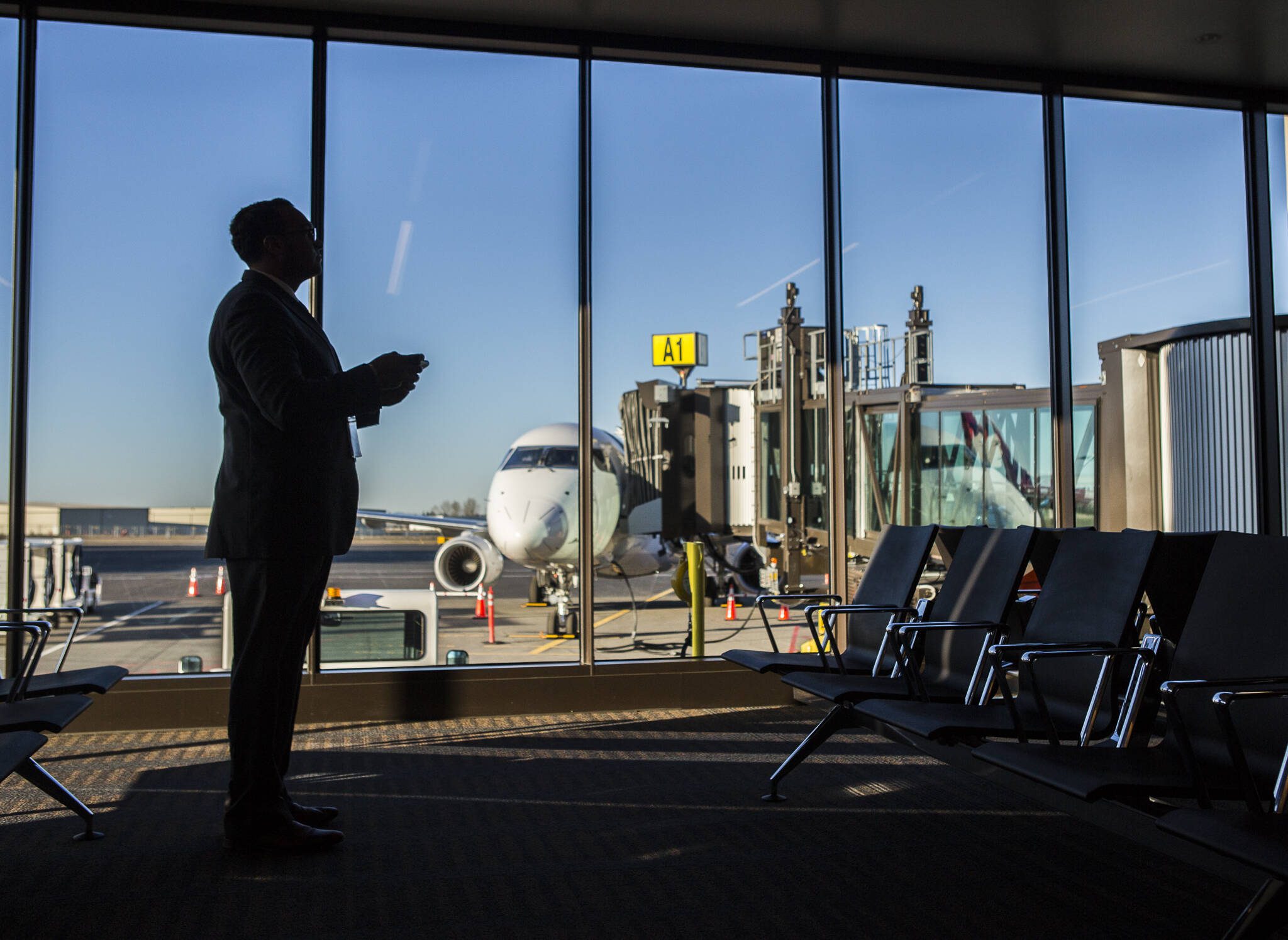 A passenger waits to board a flight at Paine Field on Monday, March 4, 2019 in Everett, shortly after regular passenger service began at the new terminal. (Olivia Vanni / The Herald file photo)