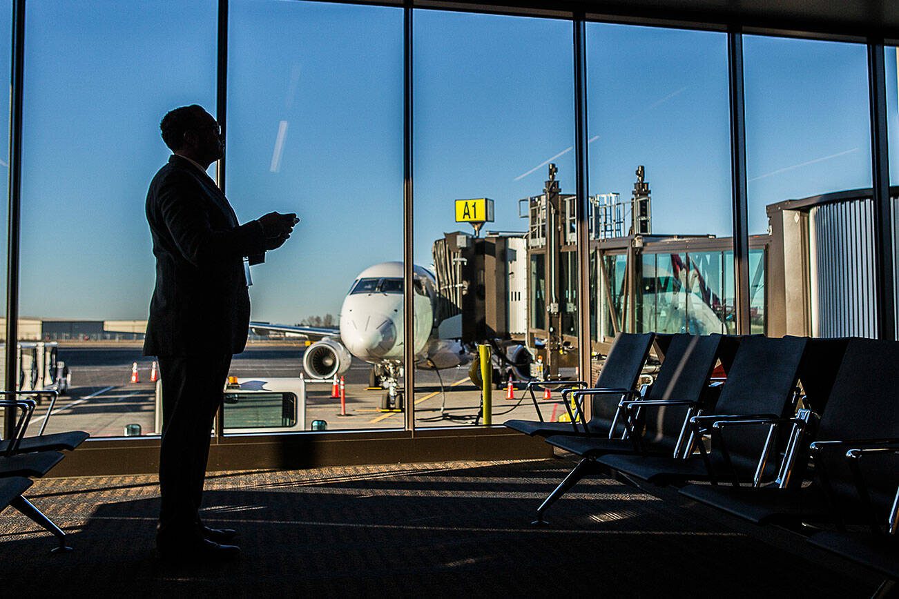 A man waits to board his flight at Paine Field on Monday, March 4, 2019 in Everett, Wa. (Olivia Vanni / The Herald)