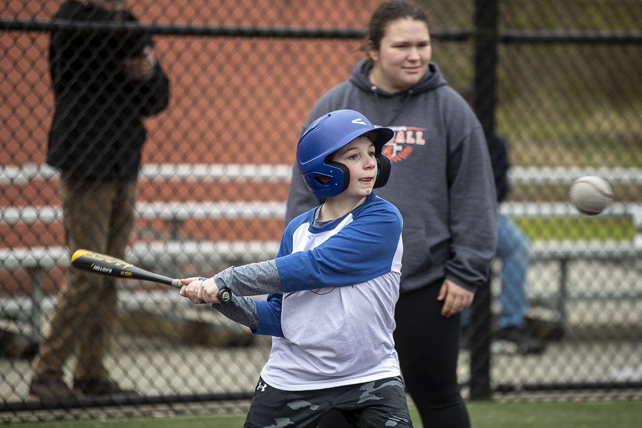 Alex Rice, 11, swings during a game of YMCA's Miracle League Baseball at Monroe Rotary Field in Monroe, Washington on Saturday, April 22, 2023. The program is designed to allow people with diverse abilities to play baseball. (Annie Barker / The Herald)