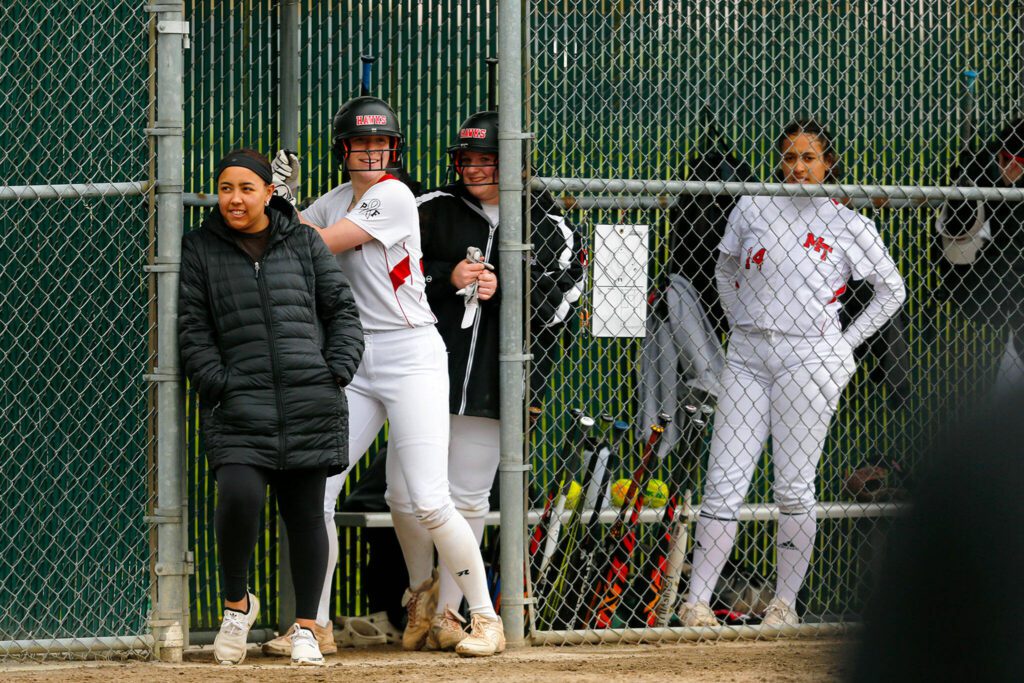 Mountlake Terrace catcher Cameron Dunn cracks a joke with some teammates while waiting in the hole during a game against Archbishop Murphy on Tuesday, April 18, 2023, at her team’s home field in Mountlake Terrace, Washington. (Ryan Berry / The Herald)
