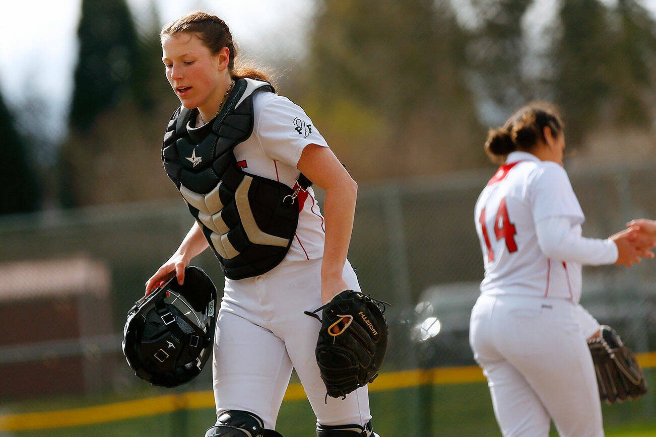 Mountlake Terrace catcher Cameron Dunn heads back behind the plate after a meeting at the mound during a game against Archbishop Murphy on Tuesday, April 18, 2023, at her team’s home field in Mountlake Terrace, Washington. (Ryan Berry / The Herald)