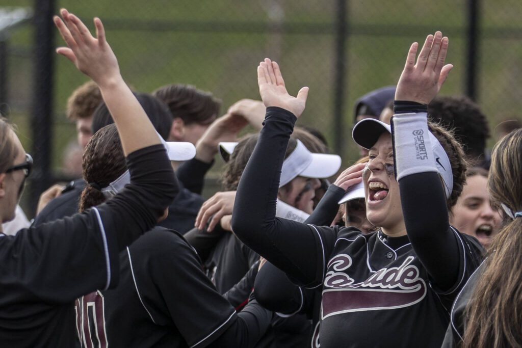 Casece players celebrate during an Everett and Cascade softball game at Phil Johnson Ballfields in Everett, Washington on Friday, April 21, 2023. Cascade won, 12-2. (Annie Barker / The Herald)
