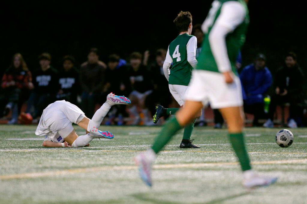 Shorewood’s Dzanan Fikic takes a hard tumble and loses the ball against Edmonds-Woodway on Friday, April 21, 2023, at Edmonds Stadium in Edmonds, Washington. (Ryan Berry / The Herald)
