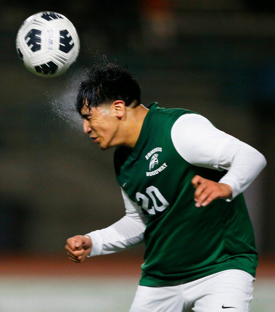 Edmonds-Woodway defender Antony Cesar sends the ball away with his head against Shorewood on Friday, April 21, 2023, at Edmonds Stadium in Edmonds, Washington. (Ryan Berry / The Herald)
