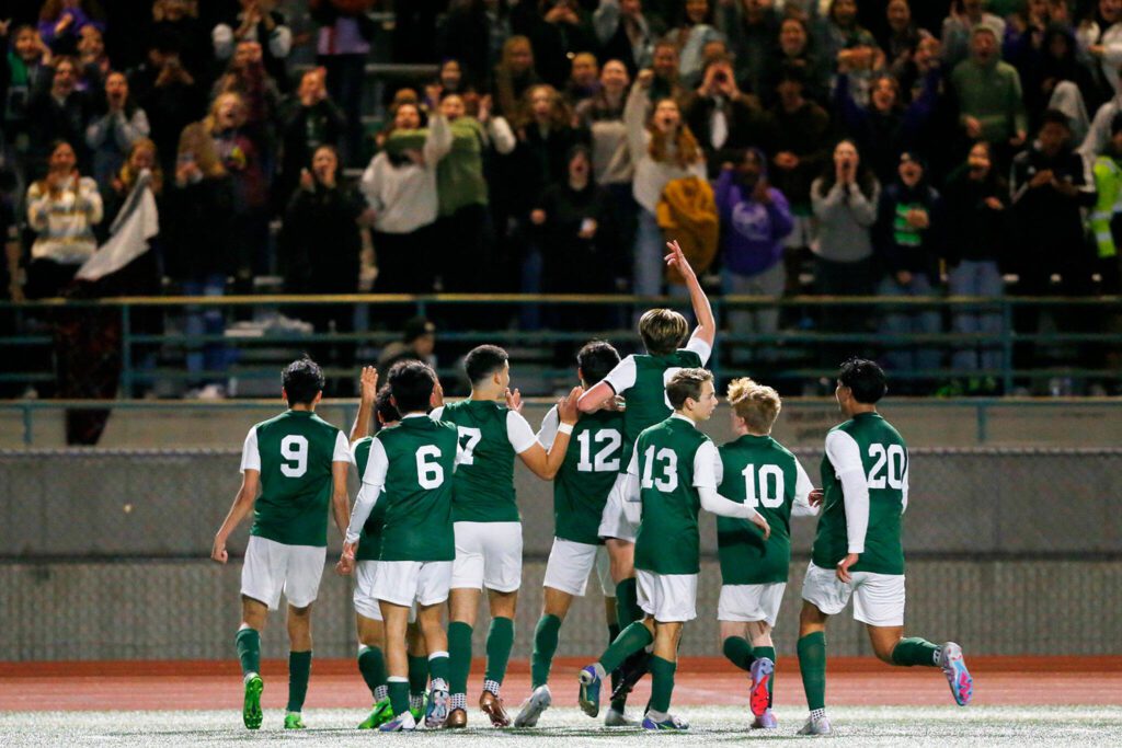 Edmonds-Woodway celebrates Andrew Montero’s game-tying penalty kick with their fans during a matchup against Shorewood on Friday, April 21, 2023, at Edmonds Stadium in Edmonds, Washington. (Ryan Berry / The Herald)
