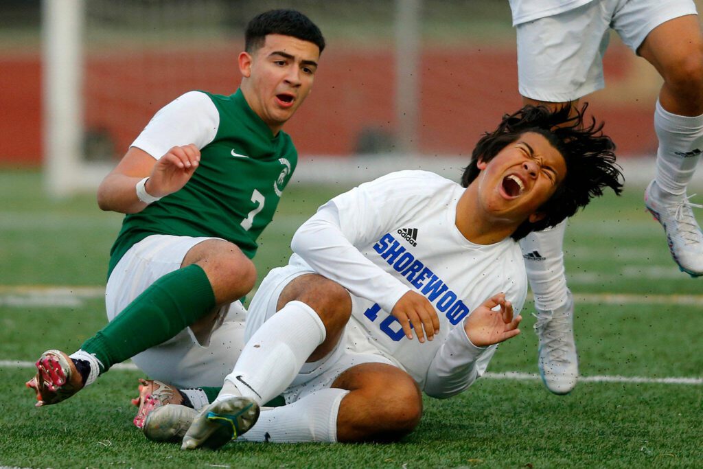 Shorewood freshman Isak Medhaug lets out a yell after colliding with Edmonds-Woodway’s Andrew Montero on Friday, April 21, 2023, at Edmonds Stadium in Edmonds, Washington. (Ryan Berry / The Herald)

