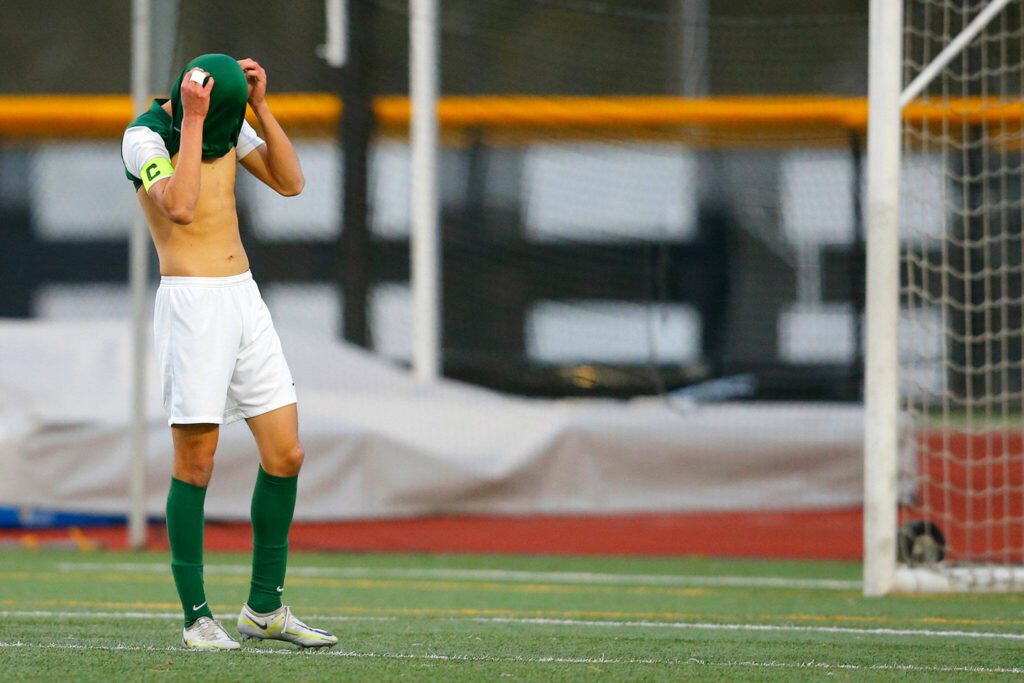 Edmonds-Woodway senior forward Victor Ibarra buries his head in his shirt after missing on a good look at the goal against Shorewood on Friday, April 21, 2023, at Edmonds Stadium in Edmonds, Washington. (Ryan Berry / The Herald)
