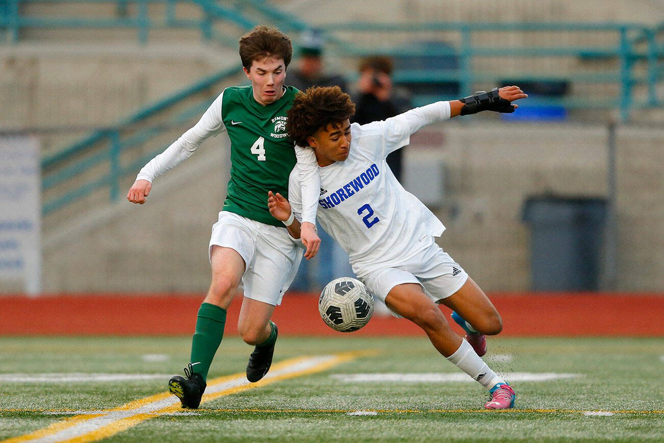 Shorewood forward Jackson Smith bullies Edmonds-Woodway’s Anthony Pellegrini off the ball during a match on Friday, April 21, 2023, at Edmonds Stadium in Edmonds, Washington. (Ryan Berry / The Herald)