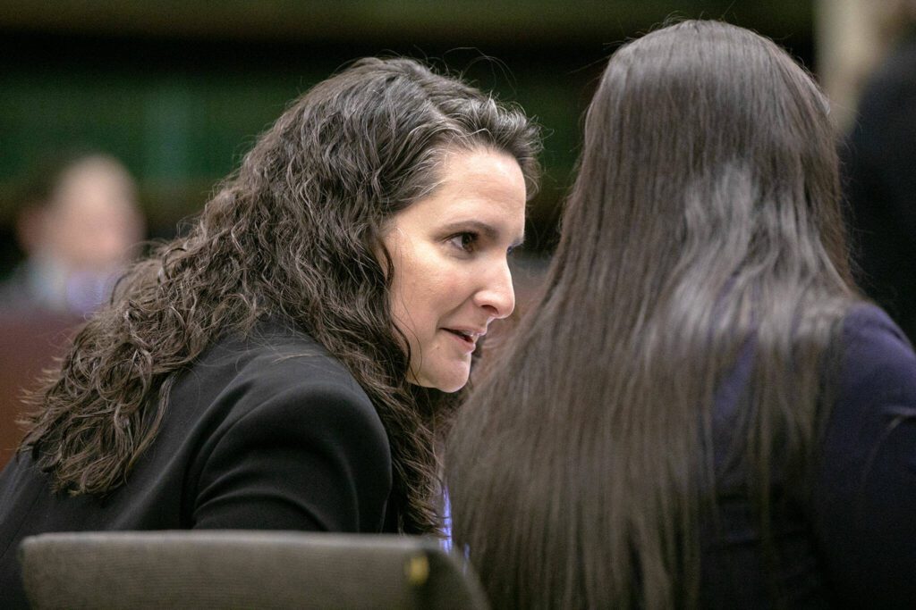 Martha Saracino turns to speak with fellow members of the prosecution during the first day of the trial of Shayne Baker on Monday, April 24, 2023, at Snohomish County Superior Court in Everett, Washington. (Ryan Berry / The Herald)
