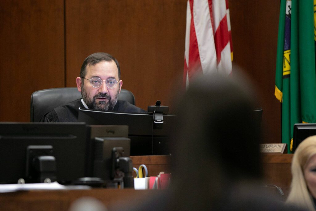 Superior Court Judge Miguel M. Duran speaks with the prosecution during the first day of the trial of Shayne Baker on Monday, April 24, 2023, at Snohomish County Superior Court in Everett, Washington. (Ryan Berry / The Herald)
