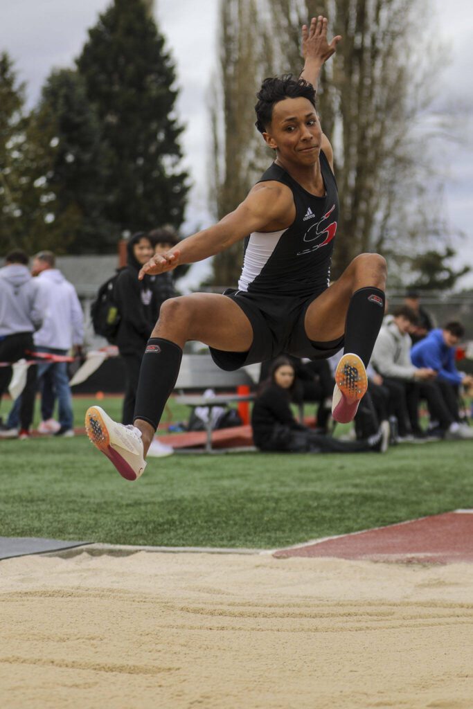 An athlete performs the triple jump during the Eason Invitational at Veterans Memorial Stadium in Snohomish, Washington on Saturday, April 22, 2023. (Annie Barker / The Herald)
