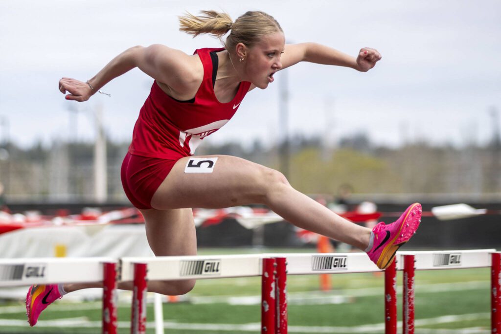Stanwood’s Abigail Danielson wins heat four of the girls 100m hurdles prelims during the Eason Invitational at Veterans Memorial Stadium in Snohomish, Washington on Saturday, April 22, 2023. (Annie Barker / The Herald)

