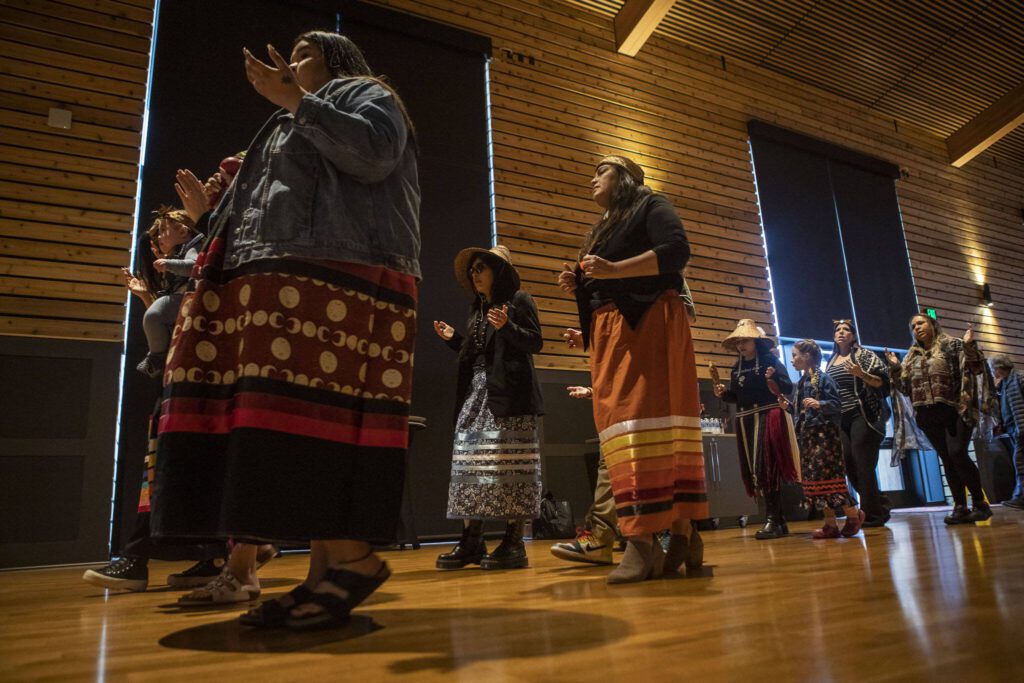A welcome song is played and sang by Tulalip performers during a Road to Healing event at the Tulalip Gathering Hall in Marysville, Washington on Sunday, April 23, 2023. The tour is lead by United States Secretary of the Interior Deb Haaland and Department of the Interior Assistant Secretary Bryan Newland. (Annie Barker / The Herald)
