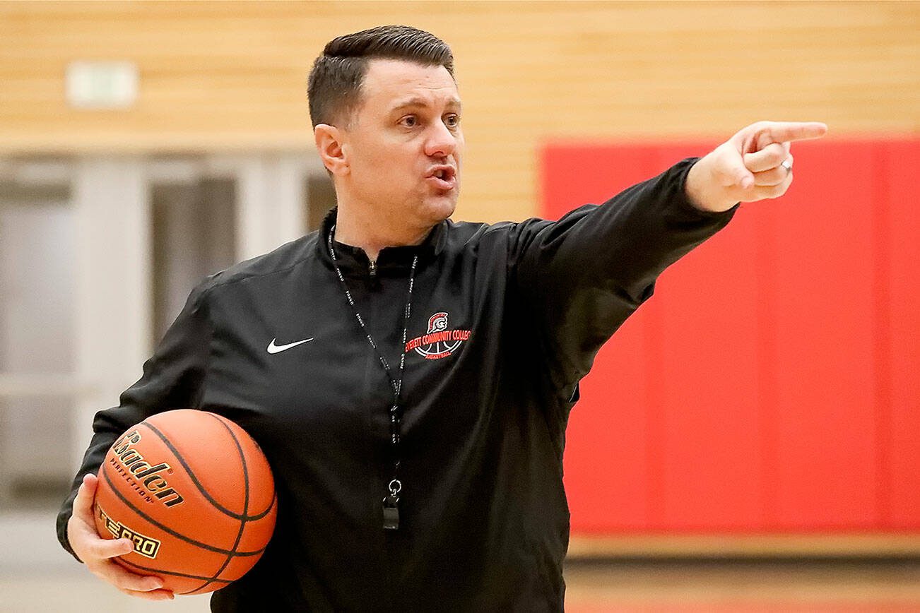 Mike Trautman, head coach, directs a play during practice Monday evening at Everett Community College in Everett on March 2, 2020.  (Kevin Clark / The Herald)