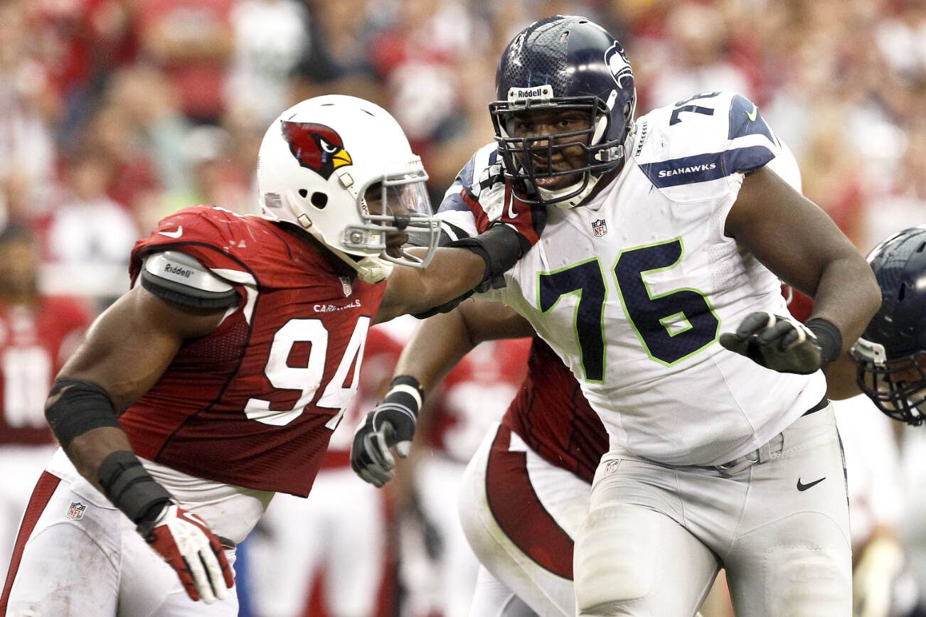 Arizona Cardinals' Sam Acho (94) tries to get past Seattle Seahawks' Russell Okung (76) during an NFL football game Sunday, Sept. 9, 2012, in Glendale, Ariz. The Cardinals defeated the Seahawks 20-16. (AP Photo/Ross D. Franklin)