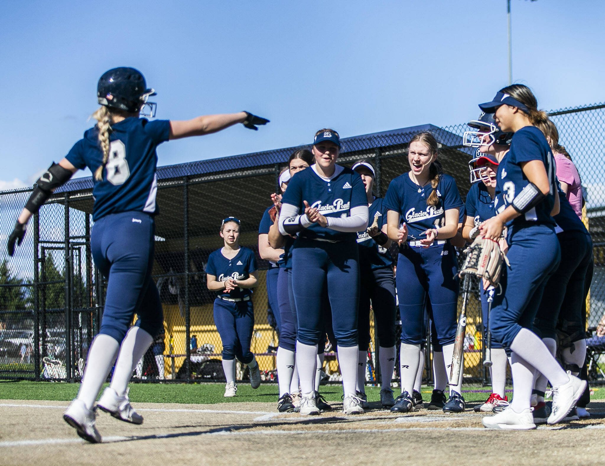 Glacier Peak’s Faith Jordan celebrates her homer with her teammates during the game against Lake Stevens on Tuesday, April 25, 2023 in Lake Stevens, Washington. (Olivia Vanni / The Herald)