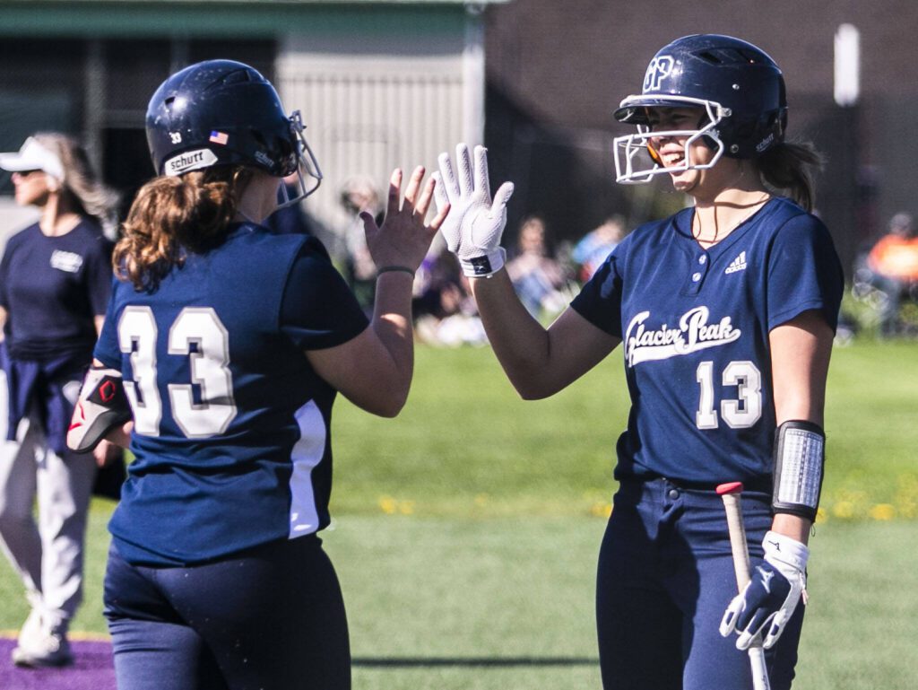 Glacier Peak’s Samantha Christensen, right, high fives teammate McKellen Hamiltonafter she scores during the game against Lake Stevens on Tuesday, April 25, 2023 in Lake Stevens, Washington. (Olivia Vanni / The Herald)
