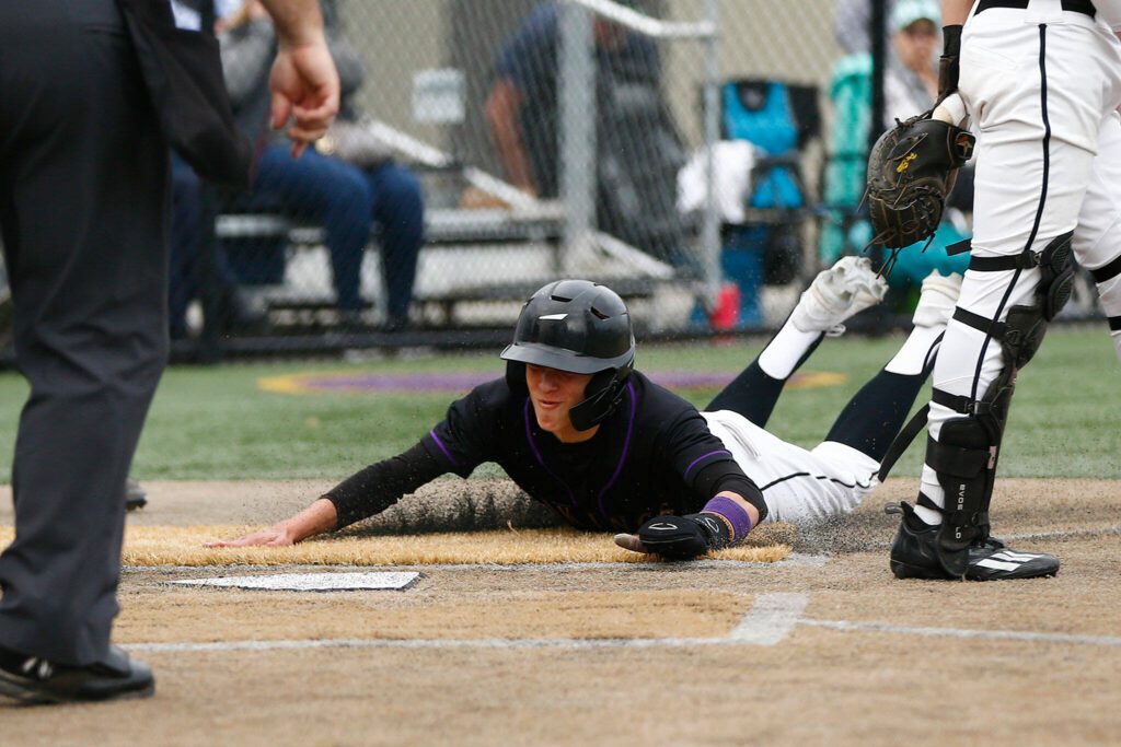 Lake Stevens’ Seth Mahler slides in safe at home in a win over Jackson on Wednesday, April 26, 2023, in Lake Stevens, Washington. (Ryan Berry / The Herald)
