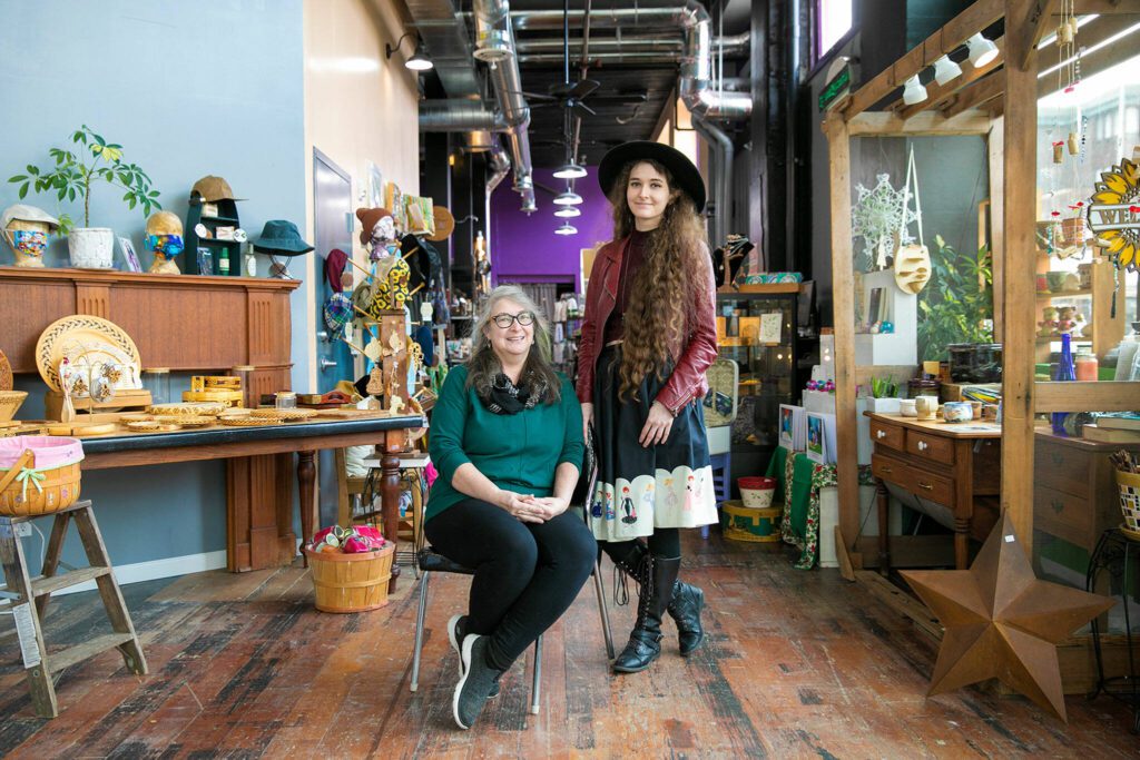 Mother-daughter duo Judi and Emma Kate Ramsey join together to run Artisans PNW on Hewitt Avenue Saturday, Nov. 26, 2022, in Everett, Washington. (Ryan Berry / The Herald)
