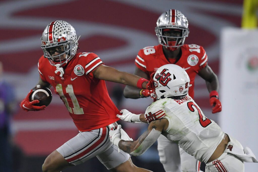 Ohio State wide receiver Jaxon Smith-Njigba (11) runs past Utah cornerback Kenzel Lawler (2) during the second half of the Rose Bowl on Jan. 1, 2022, in Pasadena, Calif. (AP Photo/John McCoy)
