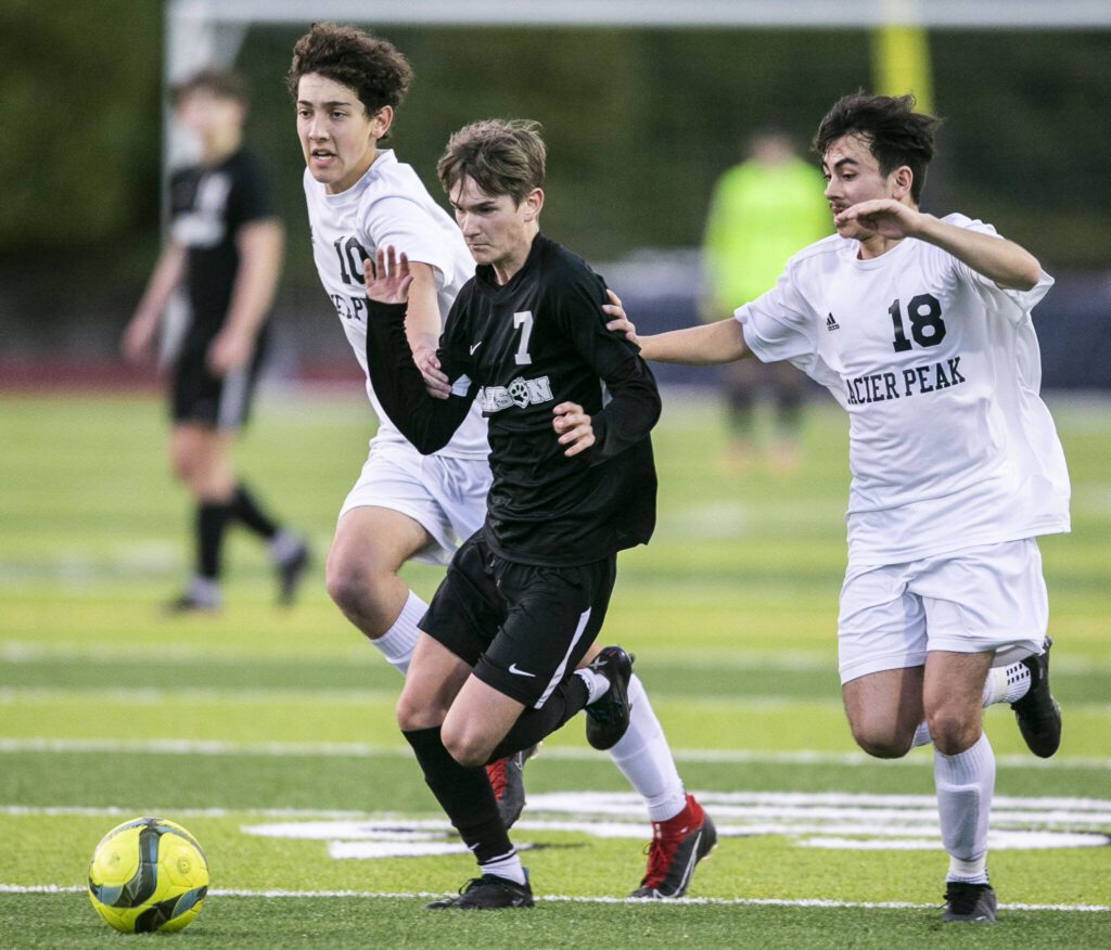 Jackson’s Vitaliy Nagomyy beats to Glacier Peak players to the ball during the game on Friday, April 28, 2023 in Snohomish, Washington. (Olivia Vanni / The Herald)
