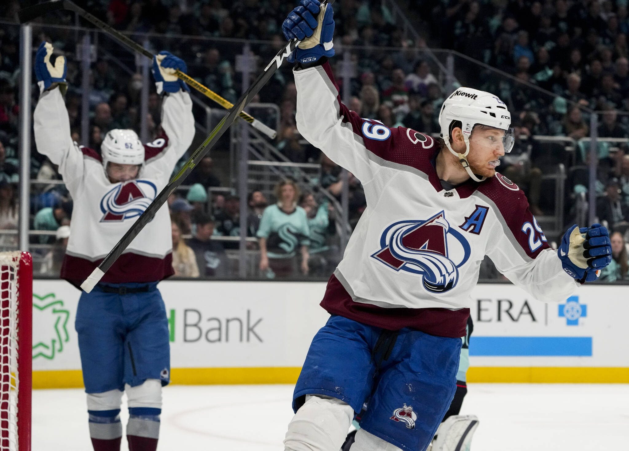 Avalanche center Nathan MacKinnon (29) and left wing Artturi Lehkonen celebrate a goal by Erik Johnson against the Kraken during the second period of Game 6 of a first-round playoff series Friday in Seattle. (AP Photo/Lindsey Wasson)