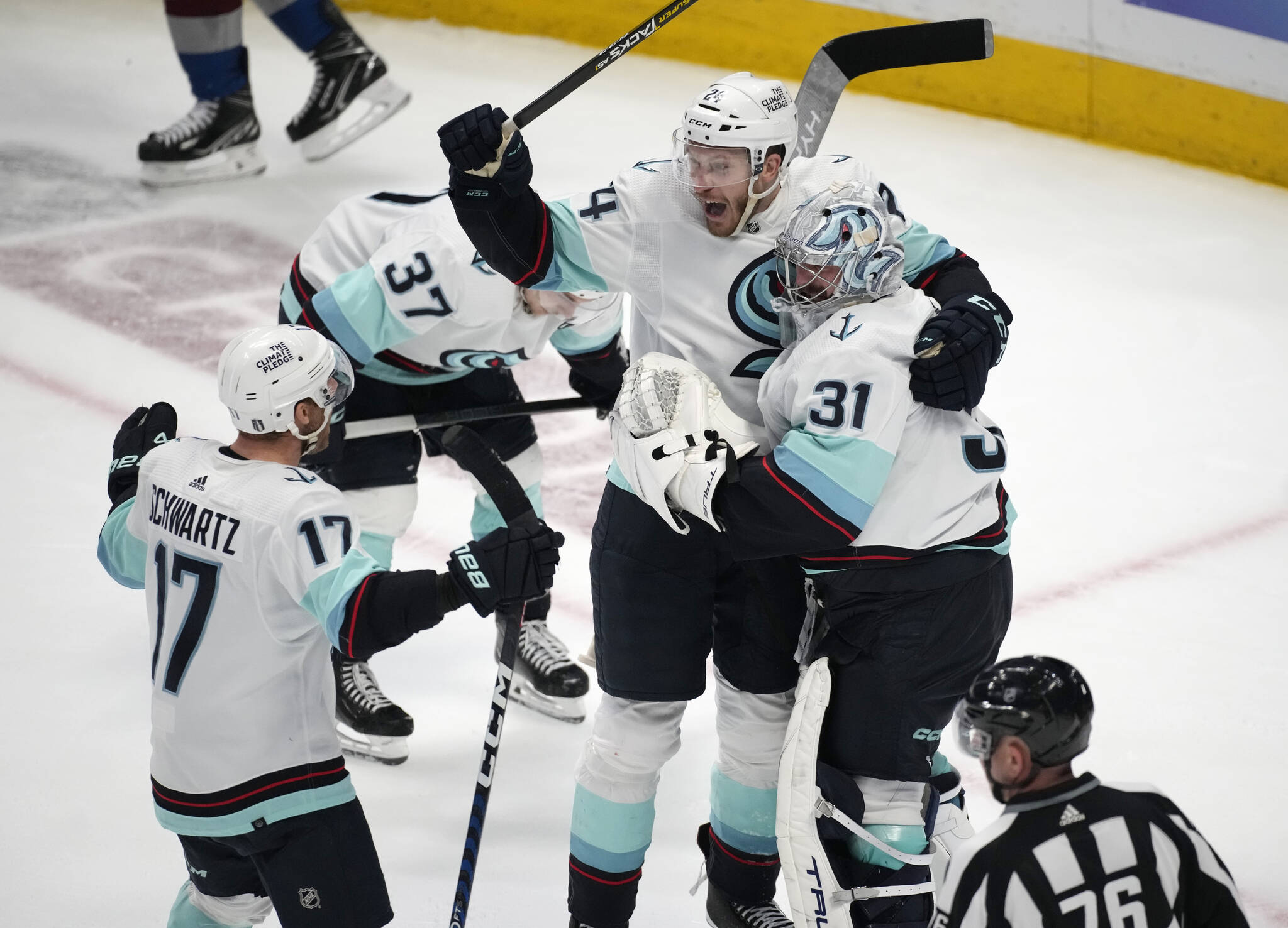 From left, Kraken center Jaden Schwartz, defenseman Jamie Oleksiak and goaltender Philipp Grubauer celebrate as time runs out in the third period of Game 7 of a first-round playoff series against the Avalanche on Sunday in Denver. The Kraken won 2-1 to advance to the next round. (AP Photo/David Zalubowski)