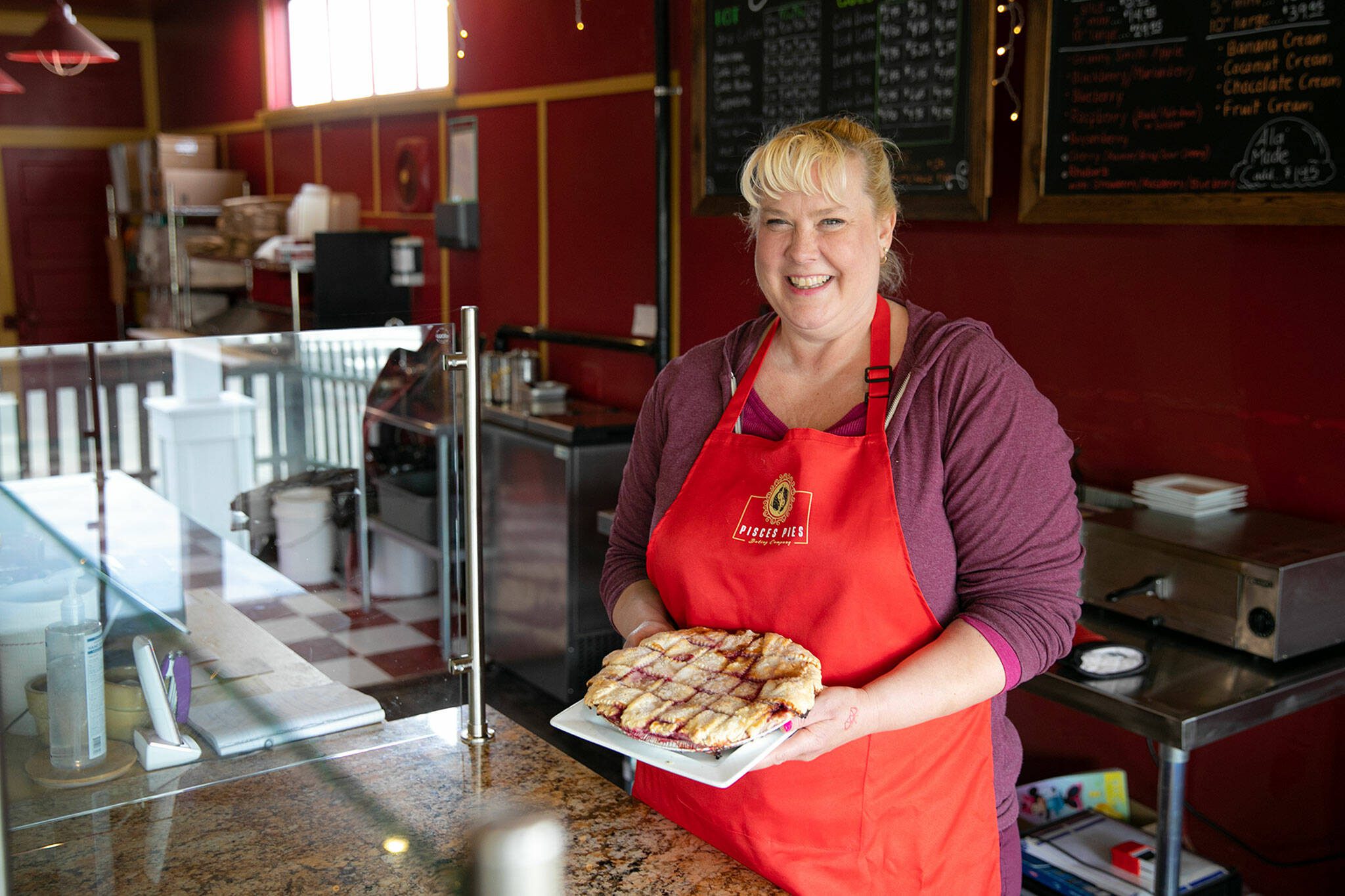 Angela Freese, owner of Everett’s newest pie shop and cafe, Pisces Pies, stands behind the counter at her Rucker Avenue storefront on Thursday, April 13, 2023, in north Everett, Washington. (Ryan Berry / The Herald)
Angela Freese, owner of Everett’s newest pie shop and cafe, Pisces Pies, stands behind the counter at her Rucker Avenue storefront on Thursday, April 13, 2023, in north Everett, Washington. (Ryan Berry / The Herald)