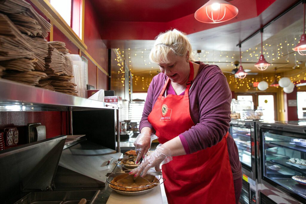 Owner Angela Freese divvies up a pie while working at her new pie shop and cafe Pisces Pies on Thursday, April 13, 2023, in north Everett, Washington. (Ryan Berry / The Herald) 
Owner Angela Freese divvies up a pie while working at her new pie shop and cafe Pisces Pies on Thursday, April 13, 2023, in north Everett, Washington. (Ryan Berry / The Herald)
