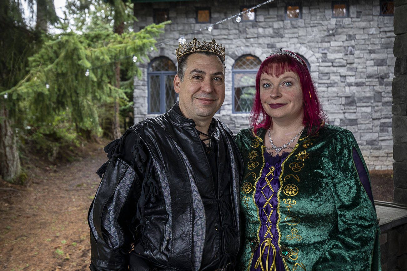 Daniel Wehnert, left, and Angela Wehnert, right, pose for a photo at High Rock Castle in Monroe, Washington on Sunday, April 9, 2023. (Annie Barker / The Herald)