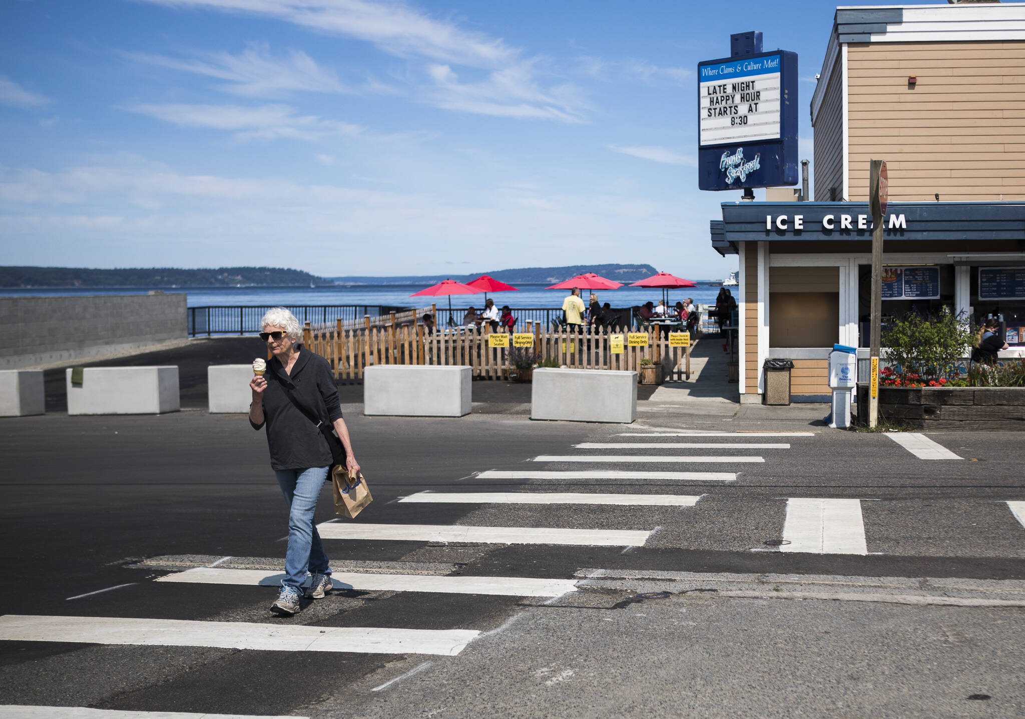 A person crosses the crosswalk in front of Ivars and the new parklet at on Thursday, Aug. 5, 2021 in Mukilteo, Wash. (Olivia Vanni / The Herald)