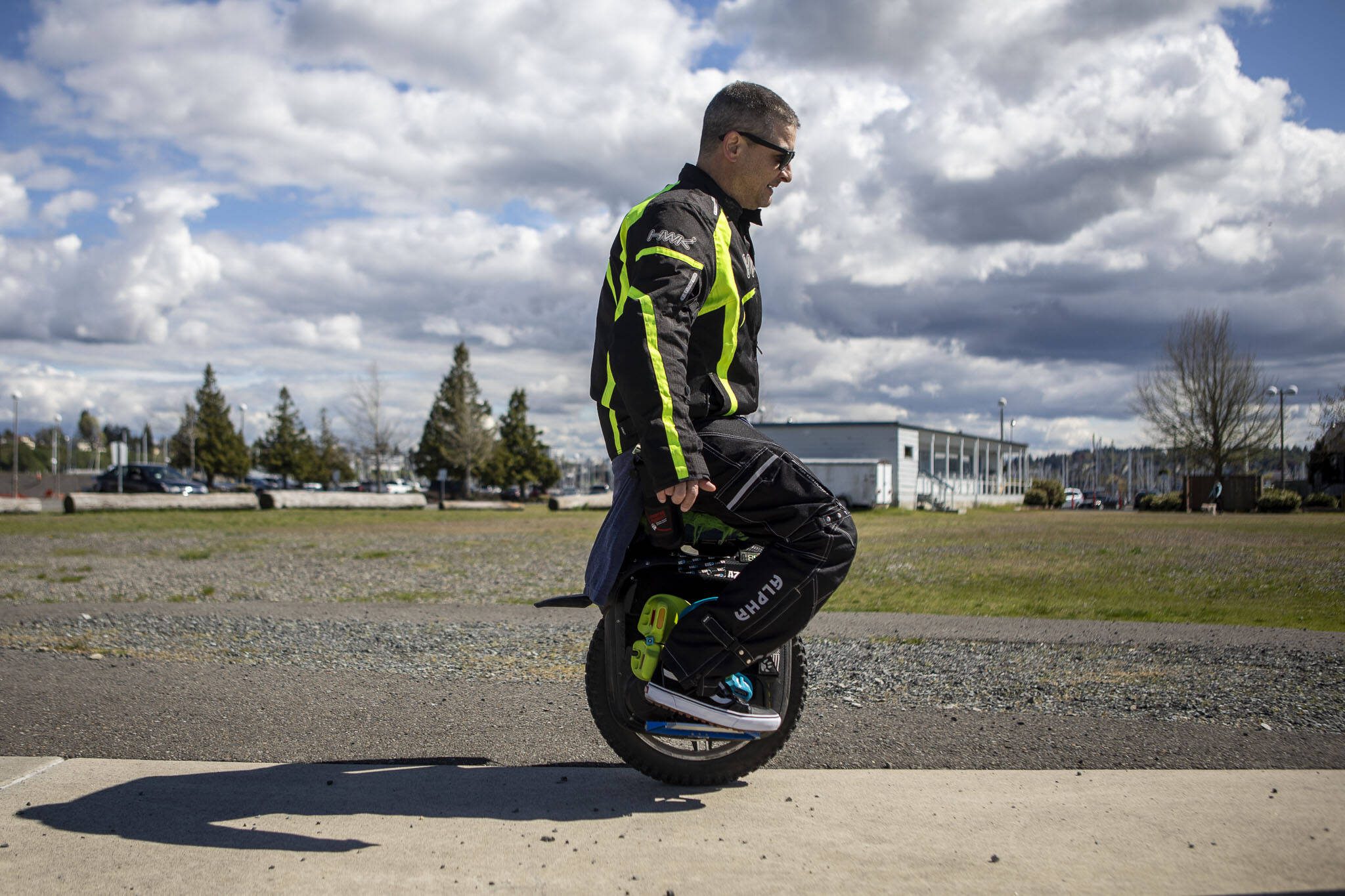 Eric Rowe, 48, demonstrates sitting on an electric unicycle at the Everett Marina in Everett, Washington on Sunday, May 7, 2023. (Annie Barker / The Herald)