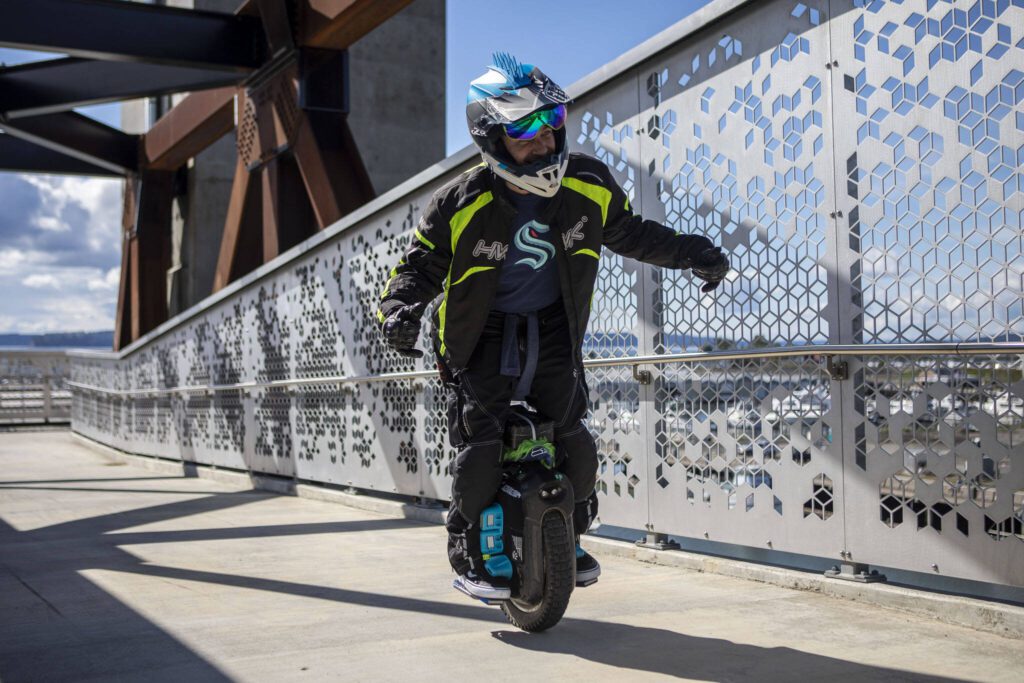 Eric Rowe, 48, rides on his electric unicycle near the Everett Marina in Everett, Washington on Sunday, May 7, 2023. (Annie Barker / The Herald)
