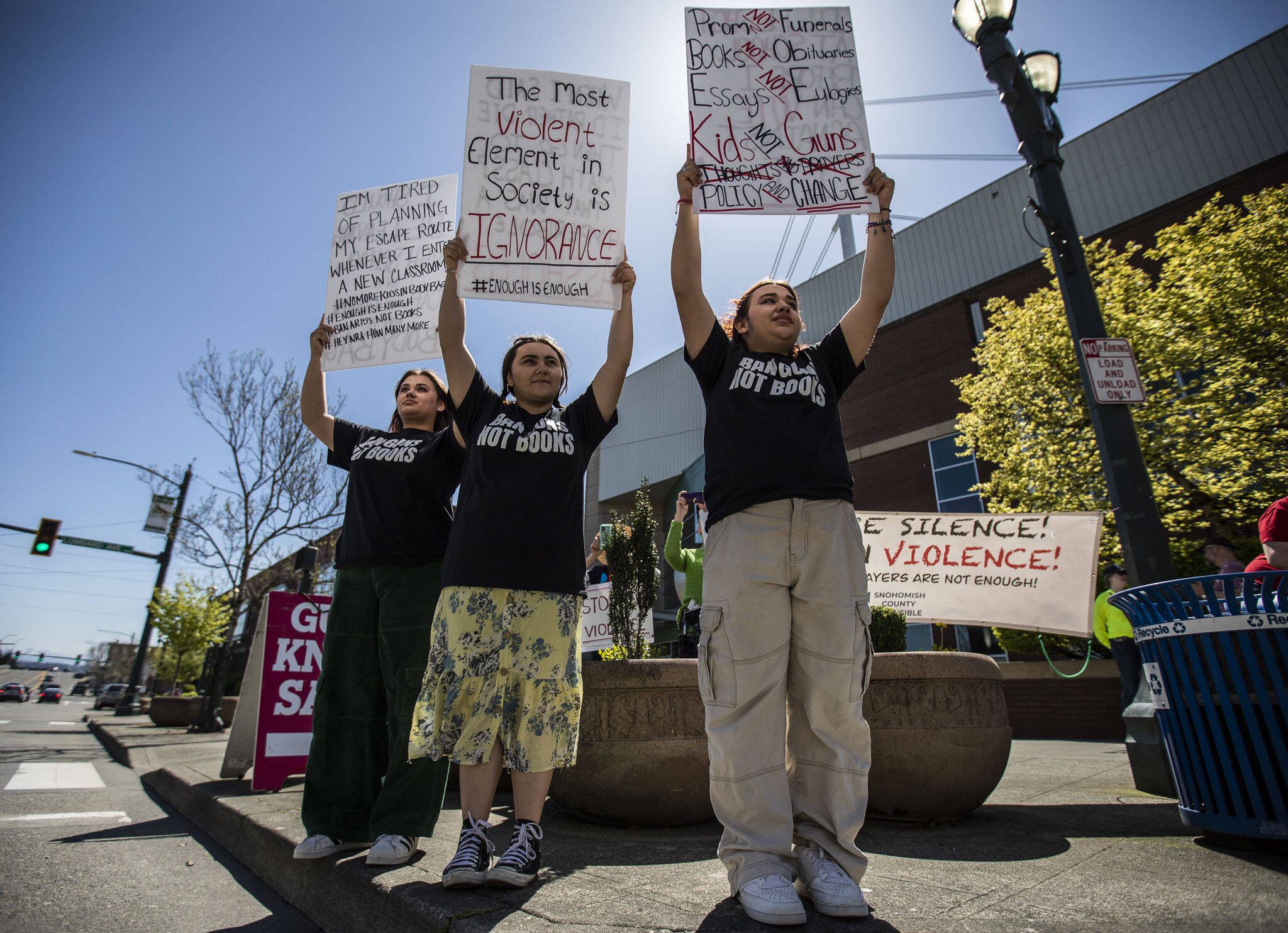 Nathan Rosas, 13 (right), Avryan Flores, 16 (center) and Angela Rosas, 16, protest outside Angel of the Winds Arena on Saturday. (Olivia Vanni / The Herald)