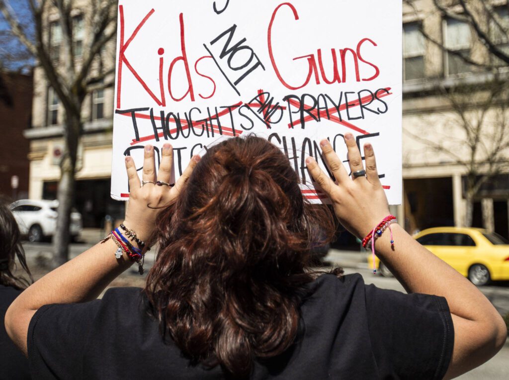 Nathan Rosas, 13, holds his sign. The protest was organized by Nathan’s mother, Amanda Hobbs of Lake Stevens. (Olivia Vanni / The Herald)

