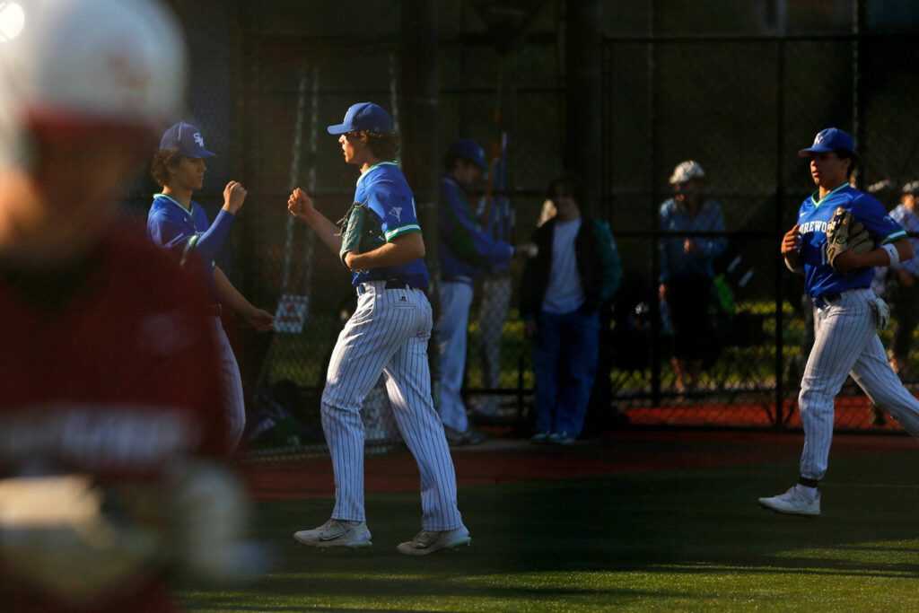 Shorewood pitcher Logan Anderson is welcomed back to the dugout by teammates after finishing an inning in a victory over Cedarcrest on Thursday, April 27, 2023, at Meridian Park in Shoreline, Washington. (Ryan Berry / The Herald)
