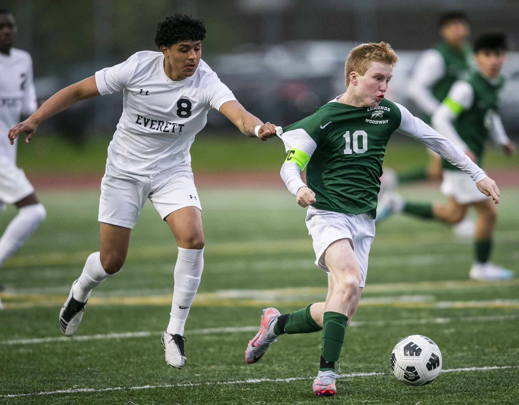 Everett’s Liang Soto-Jimenez grabs the jersey of Edmonds-Woodway’s Ben Hanson during the game on Monday in Edmonds. (Olivia Vanni / The Herald)