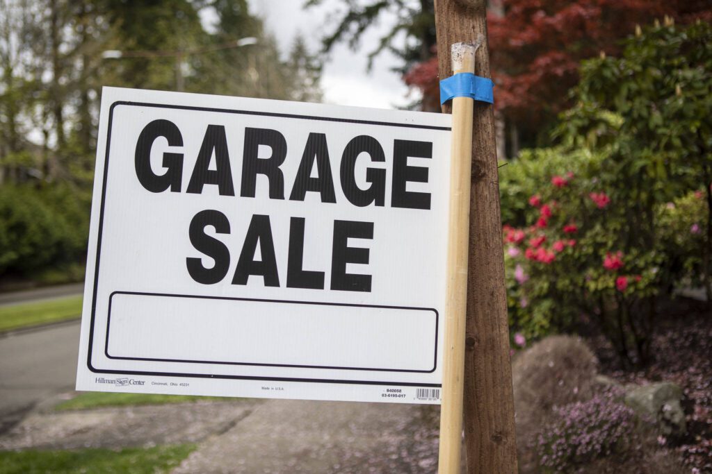 A sign for a garage sale in Mill Creek, Washington on Saturday, May 6, 2023. (Annie Barker / The Herald)
