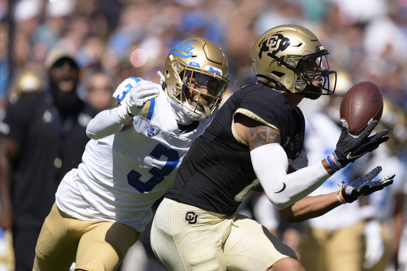 Colorado wide receiver Daniel Arias, front, pulls in a pass in front of UCLA defensive back Devin Kirkwood in the first half of an NCAA college football game Saturday, Sept. 24, 2022, in Boulder, Colo. (AP Photo/David Zalubowski)