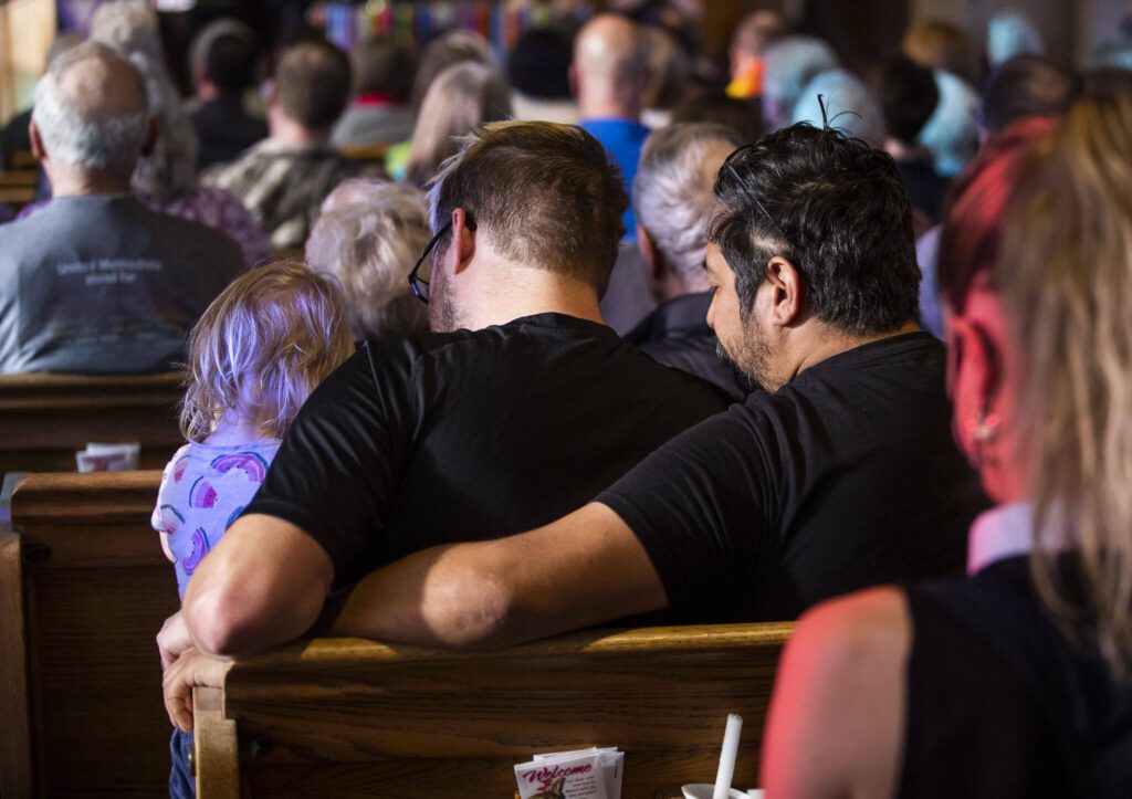 A couple embraces during the vigil held at Edmonds United Methodist Church on Tuesday, May 2, 2023 in Edmonds, Washington. (Olivia Vanni / The Herald)
