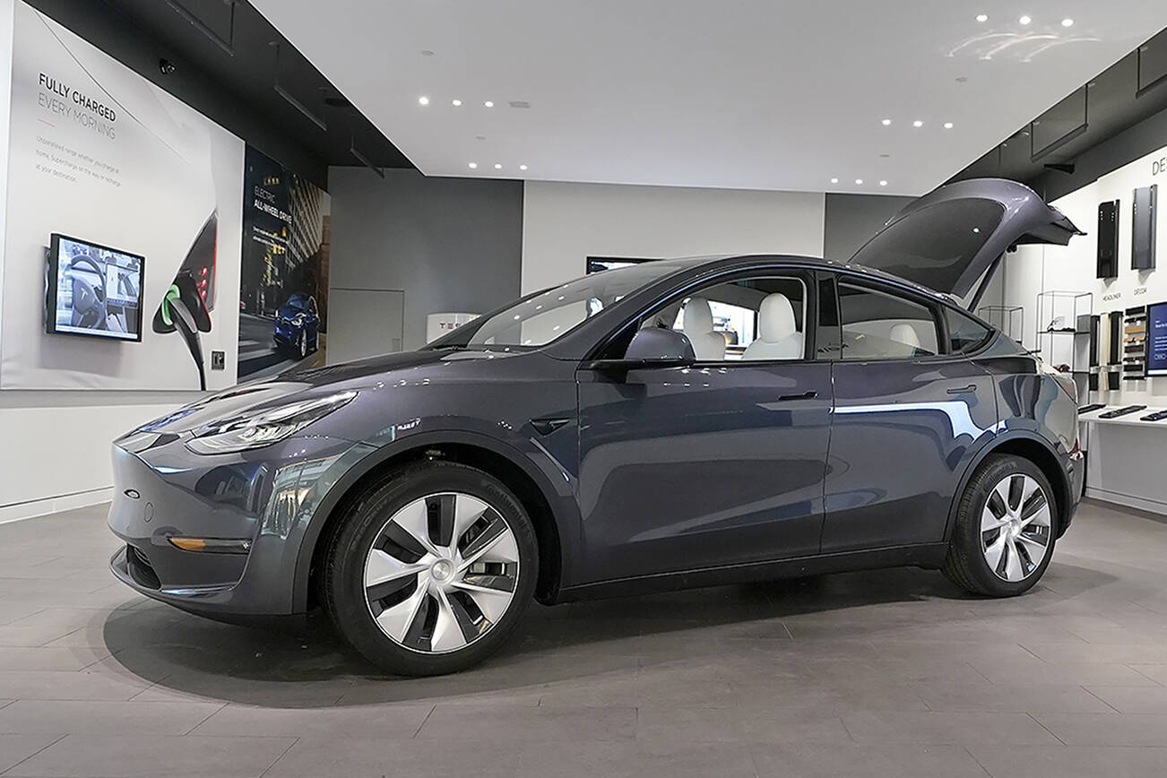 A Tesla Model Y Long Range is displayed on Feb. 24, 2021, at the Tesla Gallery in Troy, Mich.  Opinion polls show that most Americans would consider an EV if it cost less, if more charging stations existed and if a wider variety of models were available. The models are coming, but they may roll out ahead of consumer tastes. And that could spell problems for the U.S. auto industry, which is sinking billions into the new technology with dozens of new vehicles on the way.  (AP Photo/Carlos Osorio)