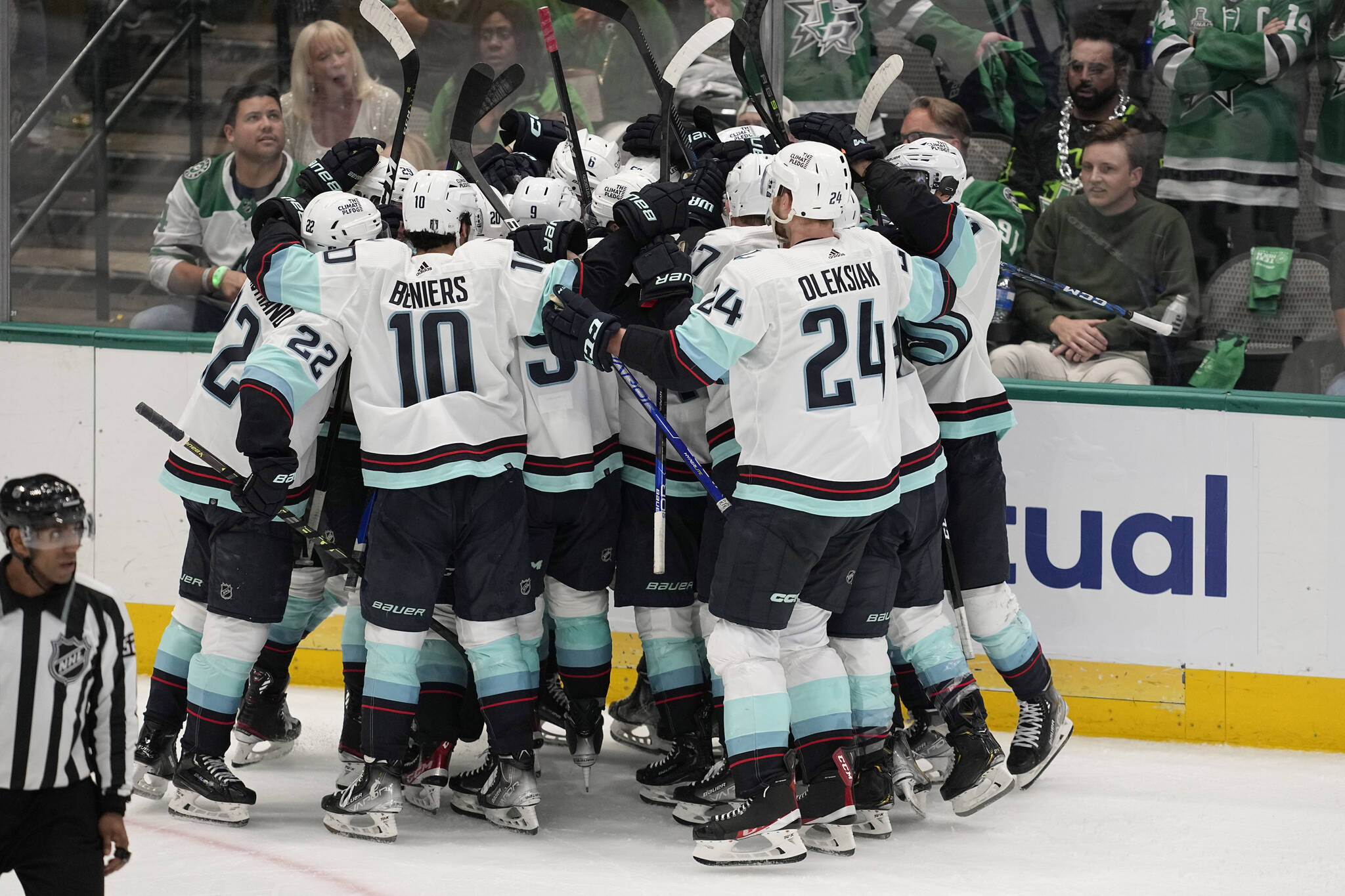 Kraken players celebrate after Yanni Gourde scored in overtime of Game 1 of a second-round playoff series against the Stars on Tuesday in Dallas. The Kraken won 5-4. (AP Photo/Tony Gutierrez)